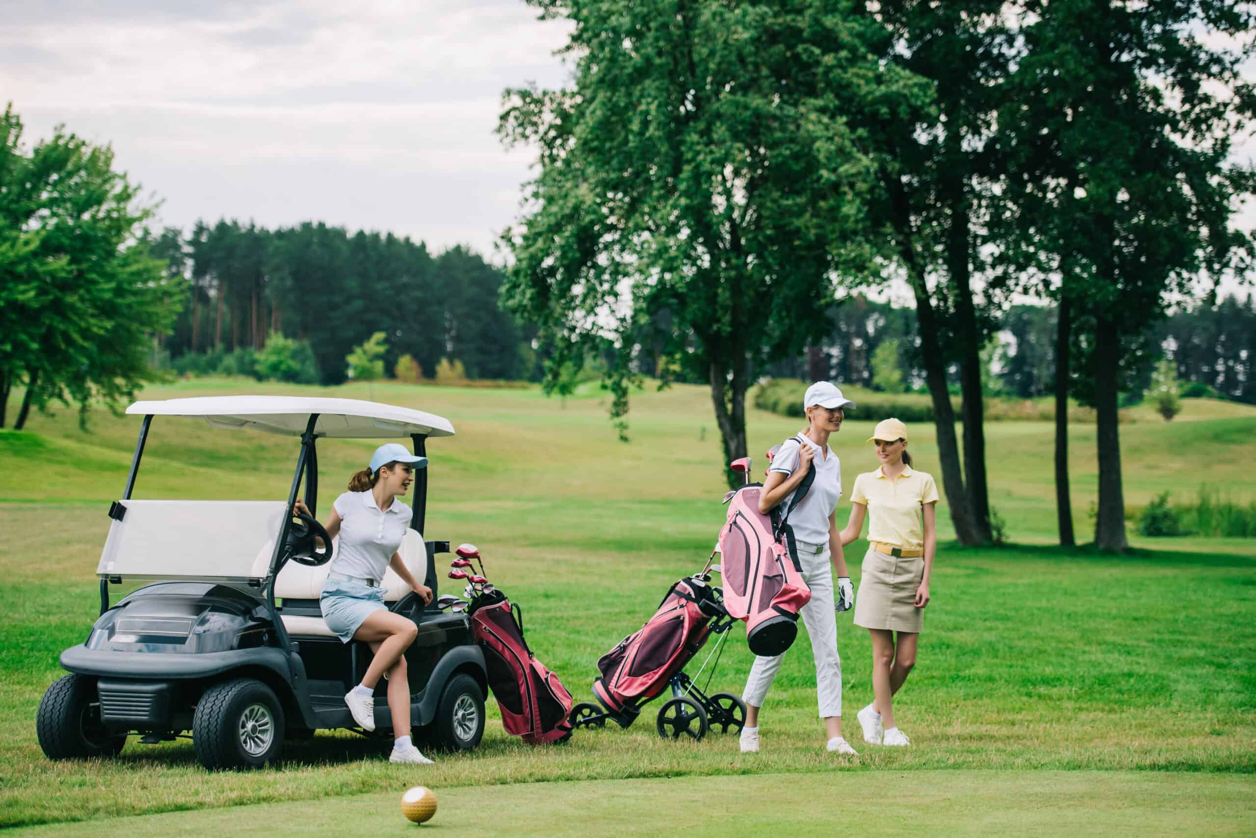 women golfers golf cart